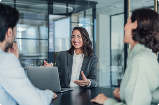 Image of a woman smiling and talking with others